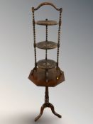 A mahogany tripod octagonal occasional table and an oak barley twist cake stand.
