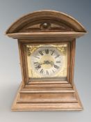 An Edwardian oak bracket clock, height 32 cm.