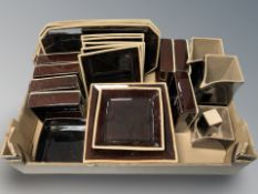 A quantity of treacle glazed ceramic dishes and jugs.