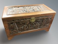 An oriental carved camphor wood blanket chest, 104 cm x 53 cm x 58 cm.