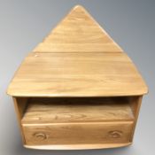 An Ercol light elm entertainment cabinet, fitted a drawer, 72 cm x 48 cm x 48 cm.