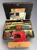 A child's tin plate Regina sewing machine and a Tekno modelling set.