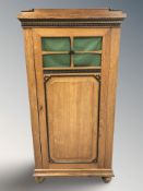 A continental oak and ebonised single door hall cabinet, 80 cm x 43 cm x 161 cm.