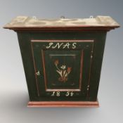A continental painted pine wall cabinet dated 1854,
