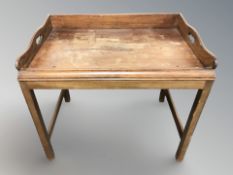 A continental walnut low table with gallery top,
