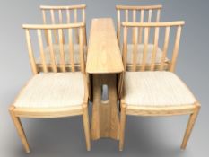 An Ercol light elm drop leaf dining table, overall 122 cm L x 107 cm W x 73 cm H,