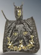 A Victorian embroidered black silk maid's pinney.