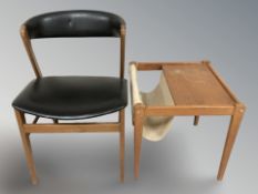 A 20th century teak and black vinyl elbow chair and an occasional table incorporating a magazine