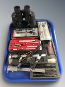 A group of precision drawing sets, pens, Swiss army knife,