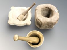 Three various mortars, two with pestles, largest 15 cm high.