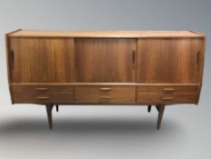 A 20th century Danish teak sliding door sideboard, 200 cm x 46 cm x 108 cm.