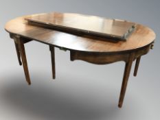 A mahogany extending oval dining table,