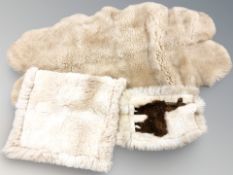 A group of sheepskin and alpaca rugs.