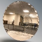 An Art Deco circular frameless etched peach glass mirror, diameter 62 cm.