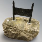 A weathered stone and iron boot scraper,