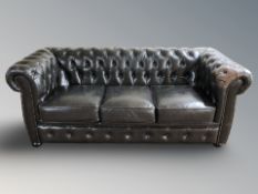 A modern Chesterfield brown buttoned and studded leather three seater settee,