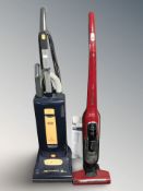 A Sebo upright vacuum cleaner and a Bosch vacuum cleaner