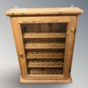 A pine glazed door wall cabinet with shelved interior, 55 cm x 18 cm x 71 cm.