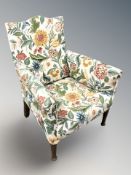 A 19th century child's armchair in floral upholstery,