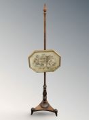 A Regency mahogany pole screen with gilt framed silk work panel
