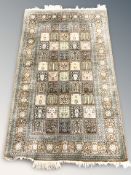 A fine Indian silk rug of compartmentalised garden design,