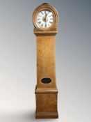 A continental satinwood drumhead longcase clock, with enameled dial, pendulum and weights,