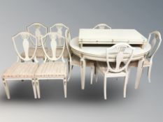 A continental painted and gilt extending dining table with four leaves,