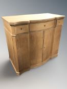 A continental oak serpentine front side cabinet,