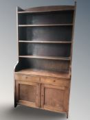 A continental mahogany open bookcase fitted cupboards,