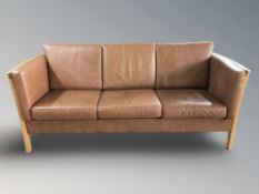 A late 20th century Danish wooden framed tan leather three seater settee, 200 cm x 84 cm x 80 cm.