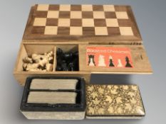 A turned boxwood chess set, a further modern folding chessboard and set of pieces,