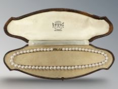 A pearl necklace on yellow 9ct gold clasp,