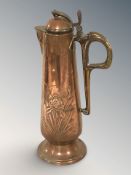 An Arts and Crafts copper tapering jug with lid, stamped GBN, height 36 cm.
