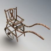 An early 20th century painted child's rickshaw seat.