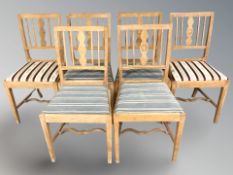 A set of six Danish blonde oak dining chairs.