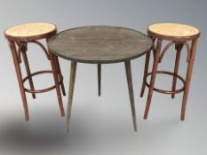 A pair of bentwood and cane stools and an occasional table.
