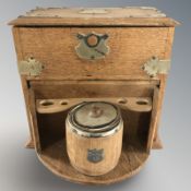 An oak smoker's cabinet with tobacco jar, width 34 cm.