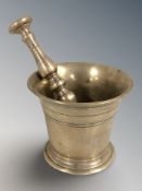 An early 19th century bronze mortar and pestle, mortar 10 cm high.