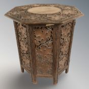 A 19th century Anglo-Indian heavily carved octagonal occasional table,