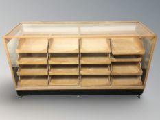 A 20th century glazed plywood haberdashery shop counter containing sixteen pull-out drawers