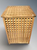 A teak lattice laundry hamper, width 46 cm, and a metal framed lamp table with pine block top.