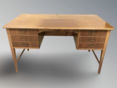 A 20th century Danish teak twin pedestal writing desk, 133 cm x 67 cm x 76 cm.