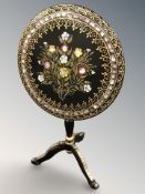 A reproduction ebonised gilt and mother of pearl inlaid folding tripod occasional table,