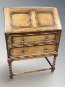 An Edwardian panelled oak fall front bureau,
