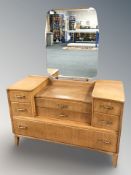 A 20th century teak sunk-centre mirror back dressing table,