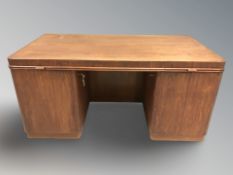 A 20th century Danish teak twin pedestal writing desk, with keys, 160 cm W x 88 cm D x 76 cm H.
