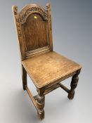 A heavily carved oak hall chair