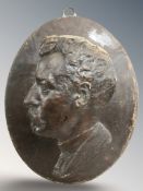 A continental ceramic relief oval wall plaque depicting a gentleman,