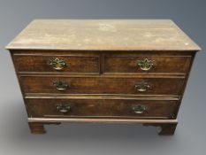 A George III oak four drawer chest on bracket feet, width 110 cm.