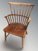 A beech spindle back armchair.